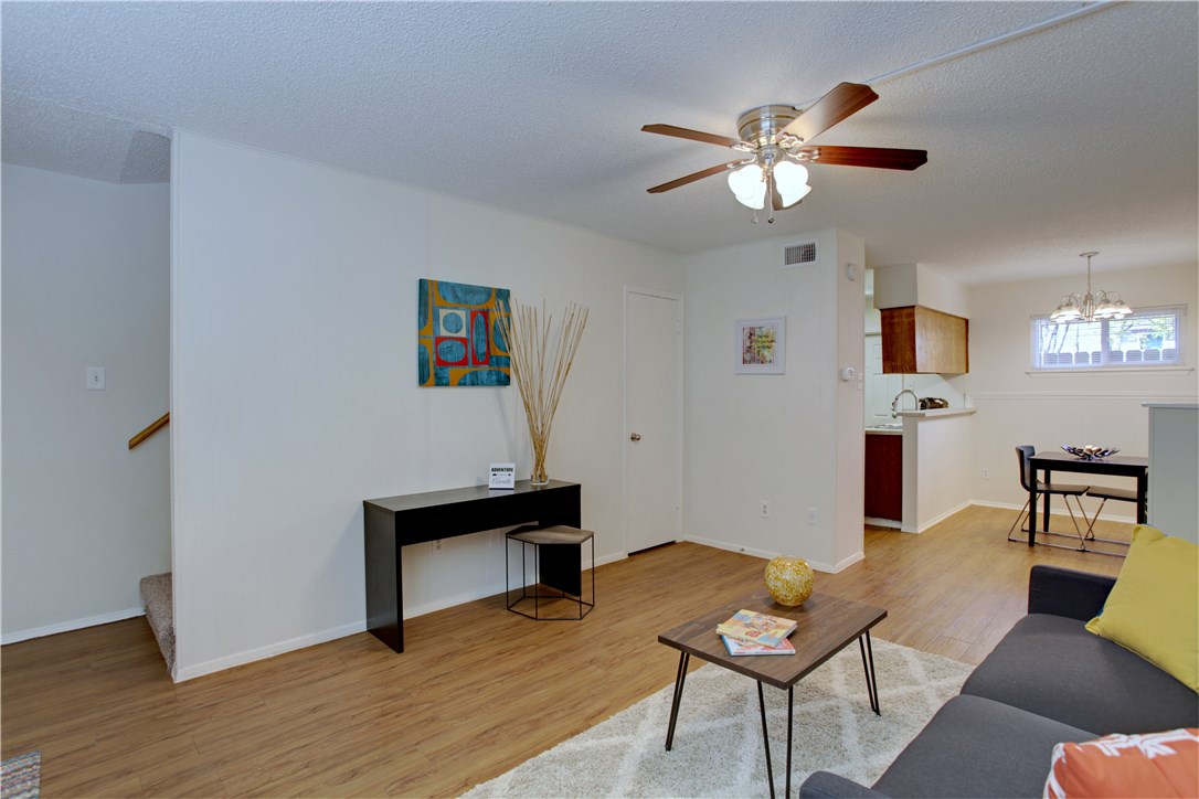 816 West N Loop Boulevard, Unit 106 Austin, TX 78756 - Photo 8 of 21 a living room with furniture and a chandelier
