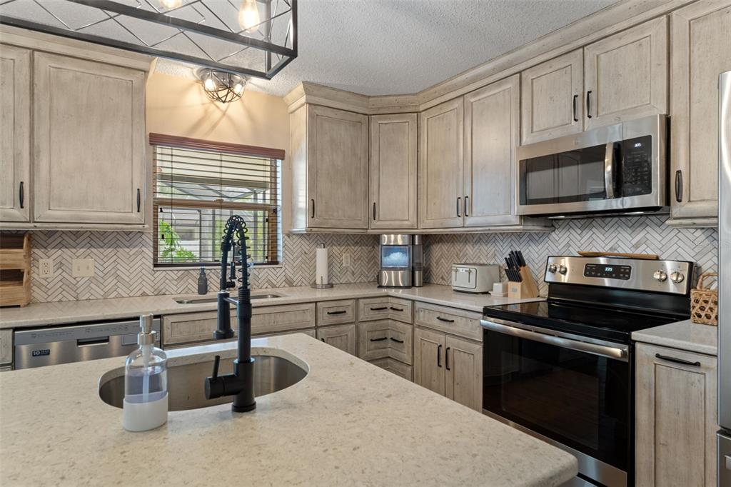 2451 Deltona Boulevard Spring Hill, FL 34606 - Photo 14 of 68 a kitchen with cabinets appliances a sink and a window