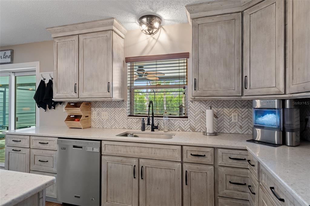 2451 Deltona Boulevard Spring Hill, FL 34606 - Photo 16 of 68 a kitchen with cabinets appliances a sink and a window