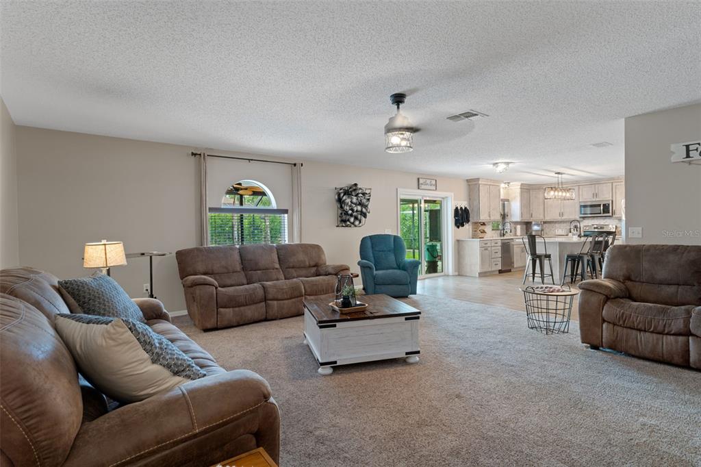 2451 Deltona Boulevard Spring Hill, FL 34606 - Photo 20 of 68 a living room with furniture and a large window