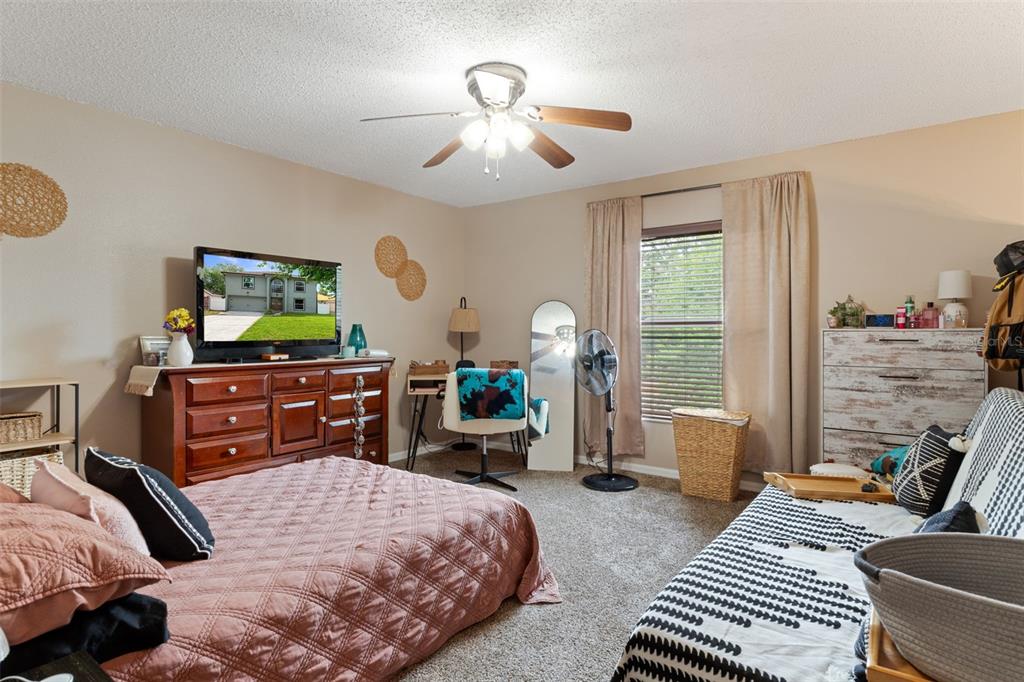 2451 Deltona Boulevard Spring Hill, FL 34606 - Photo 32 of 68 a bedroom with bed and flat screen tv