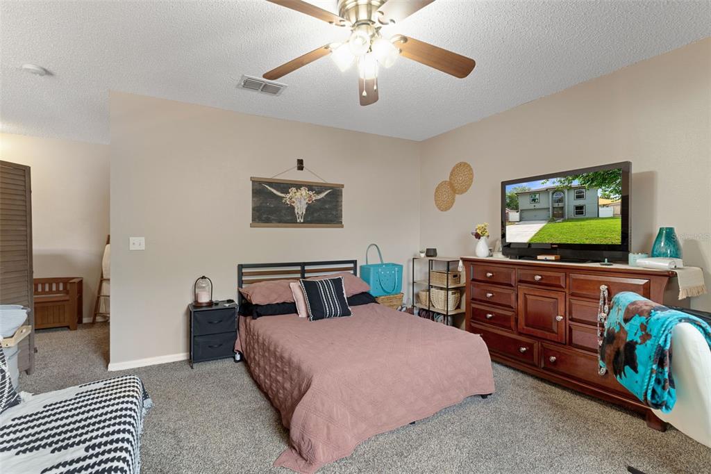 2451 Deltona Boulevard Spring Hill, FL 34606 - Photo 33 of 68 a bedroom with a bed and a flat screen tv