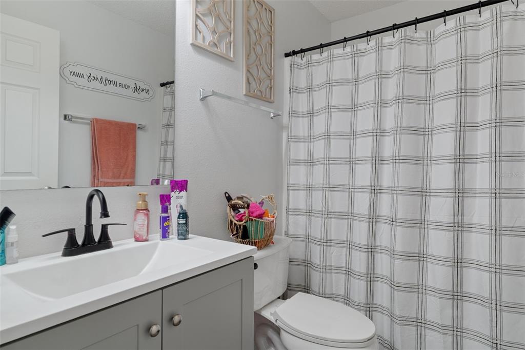 2451 Deltona Boulevard Spring Hill, FL 34606 - Photo 38 of 68 a bathroom with a sink vanity mirror and toilet