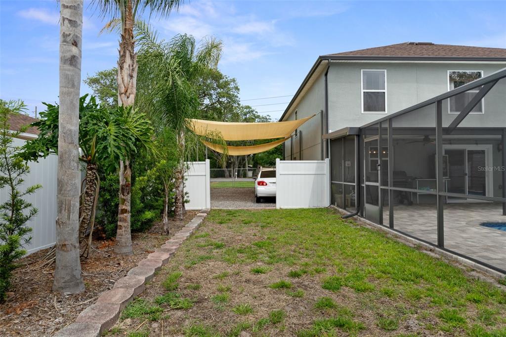 2451 Deltona Boulevard Spring Hill, FL 34606 - Photo 55 of 68 a view of a house with a yard and potted plants