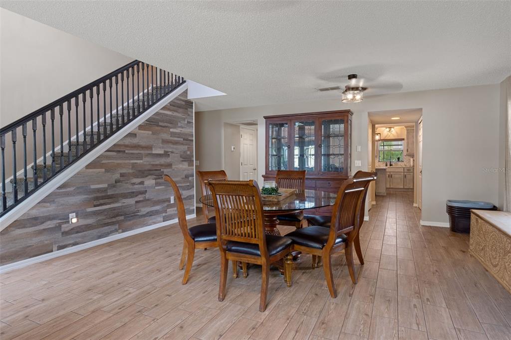 2451 Deltona Boulevard Spring Hill, FL 34606 - Photo 6 of 68 a view of a dining room with furniture and wooden floor