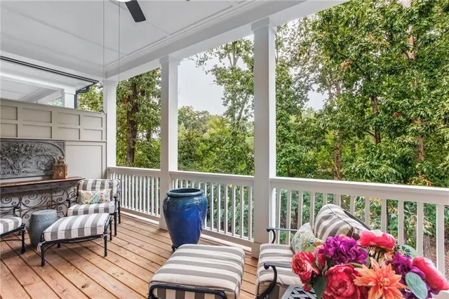 a balcony with furniture and wooden floor