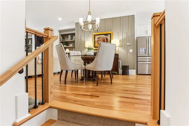 a view of a livingroom with furniture staircase and kitchen view