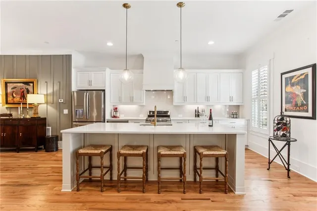 a large kitchen with a table and chairs
