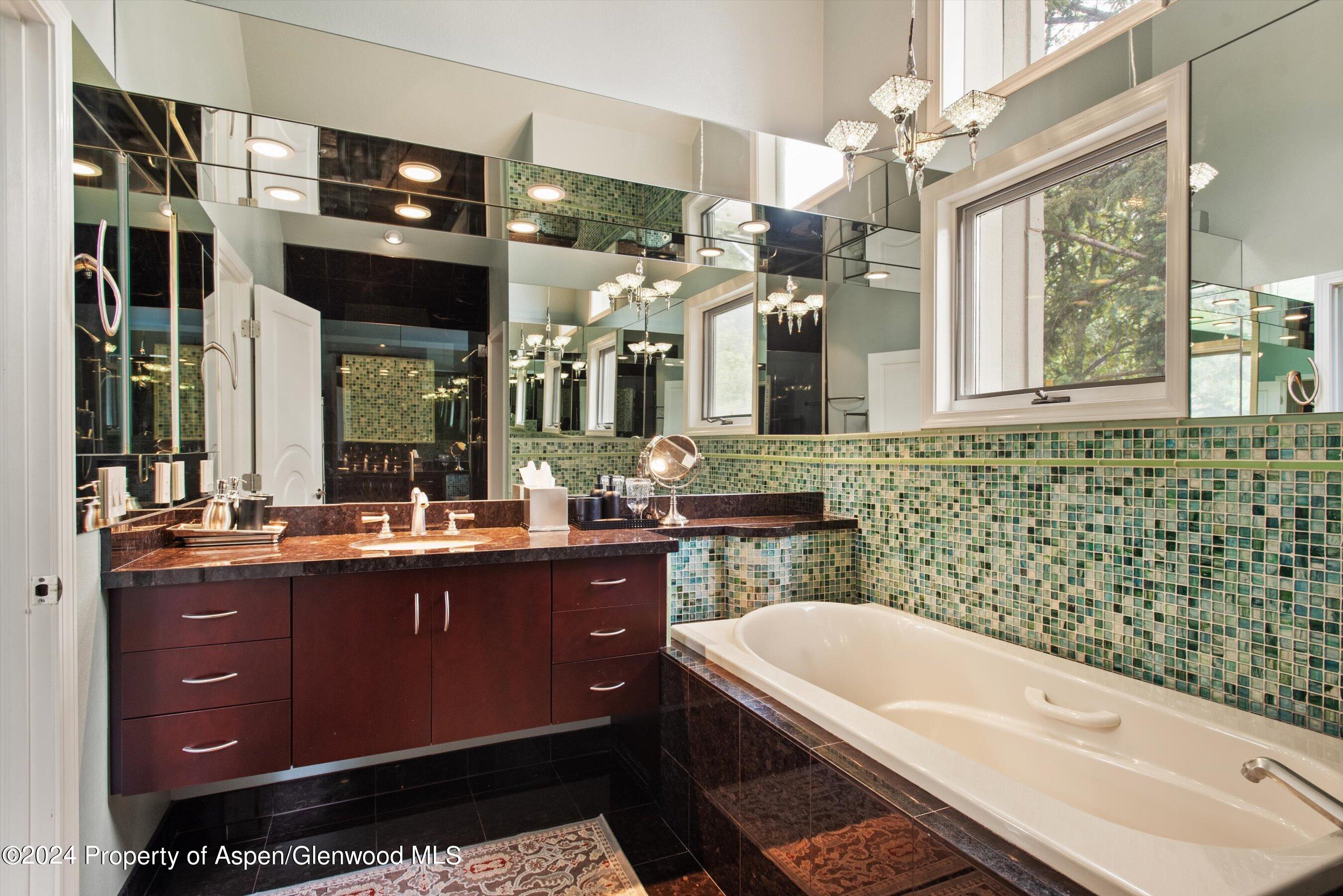 153 Wren Court Basalt, CO 81621 - Photo 13 of 21 a bathroom with a bathtub a double vanity sink a toilet a mirror and shower