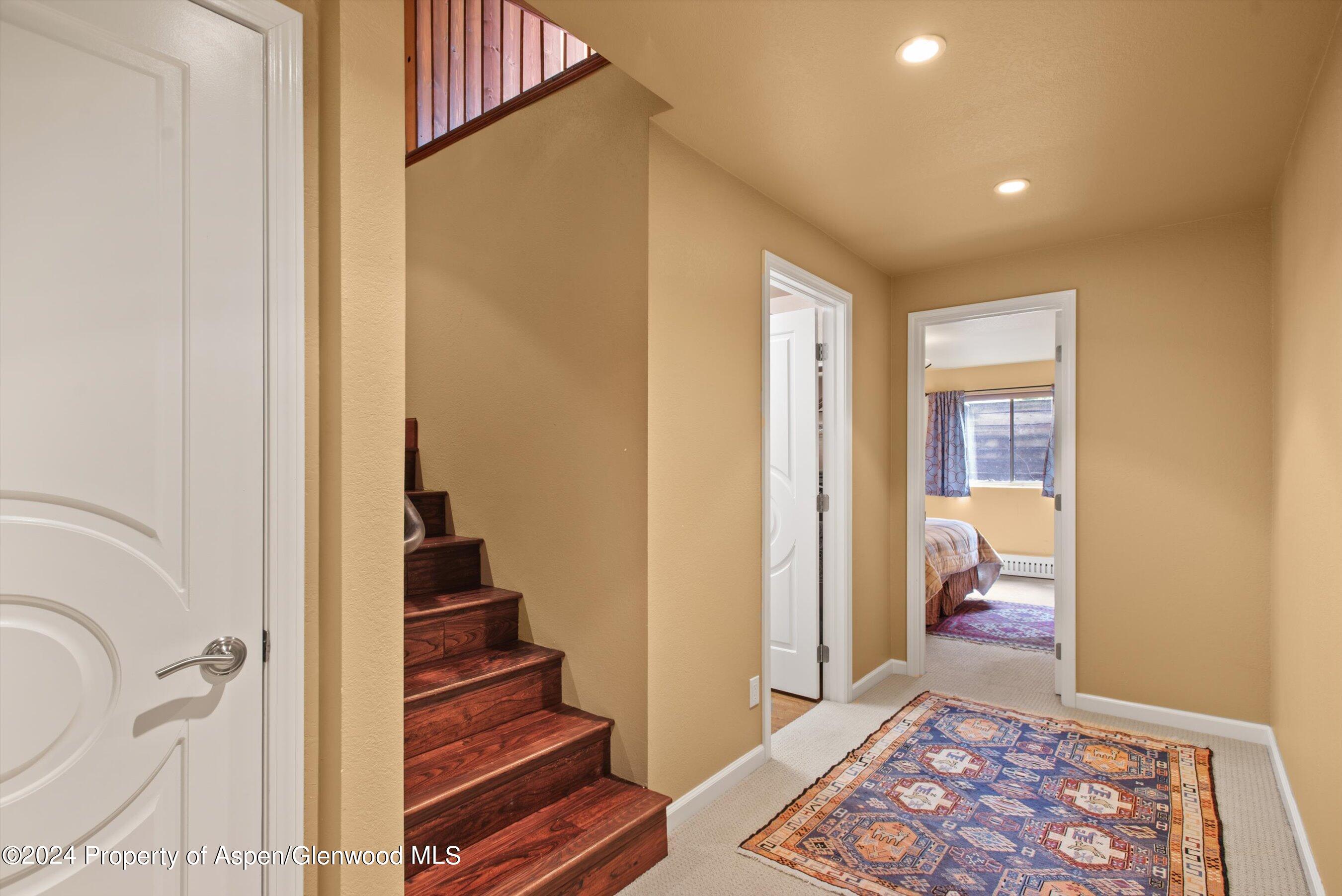 153 Wren Court Basalt, CO 81621 - Photo 19 of 21 a view of a hallway with wooden floor and bathroom