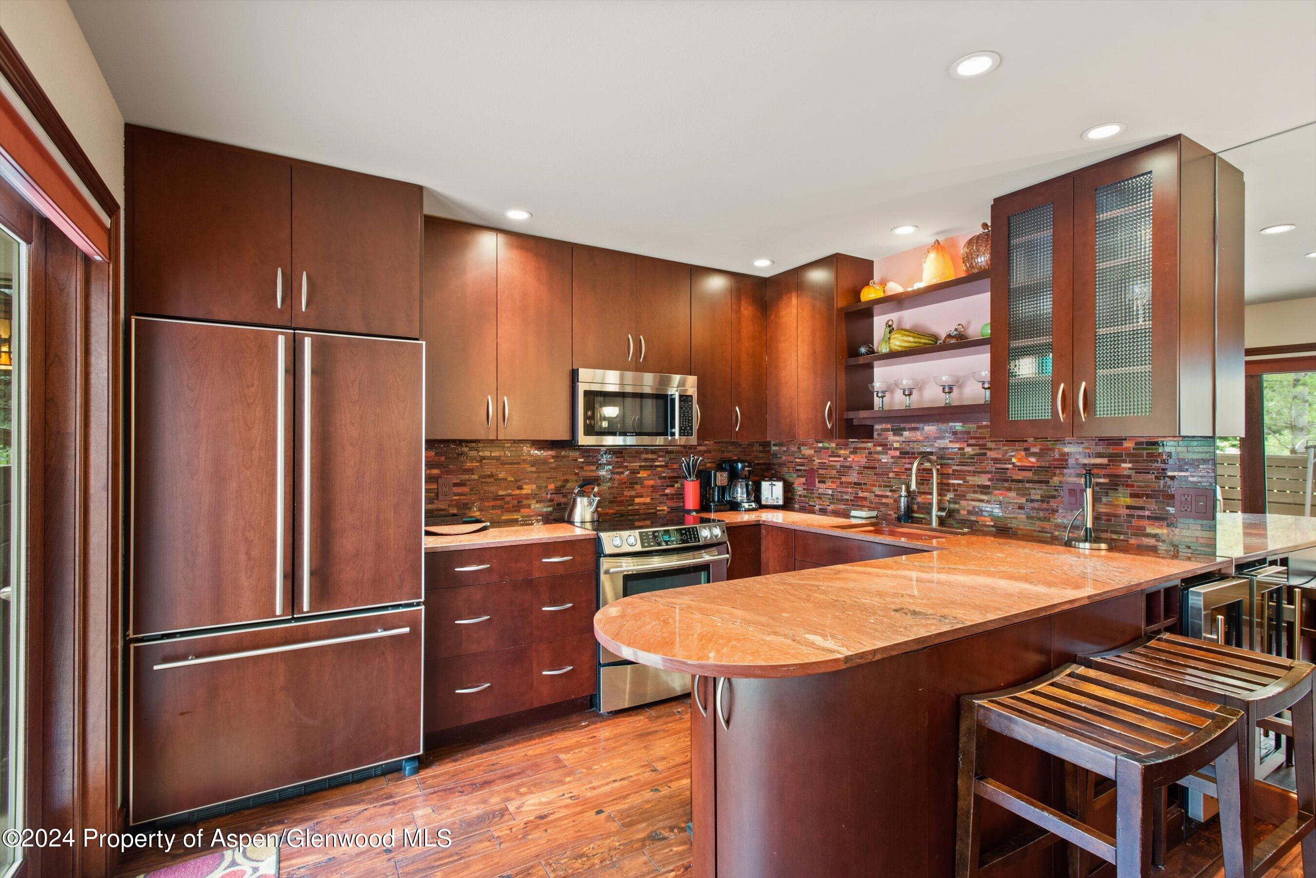 153 Wren Court Basalt, CO 81621 - Photo 6 of 21 a kitchen with stainless steel appliances granite countertop a refrigerator a sink and a stove