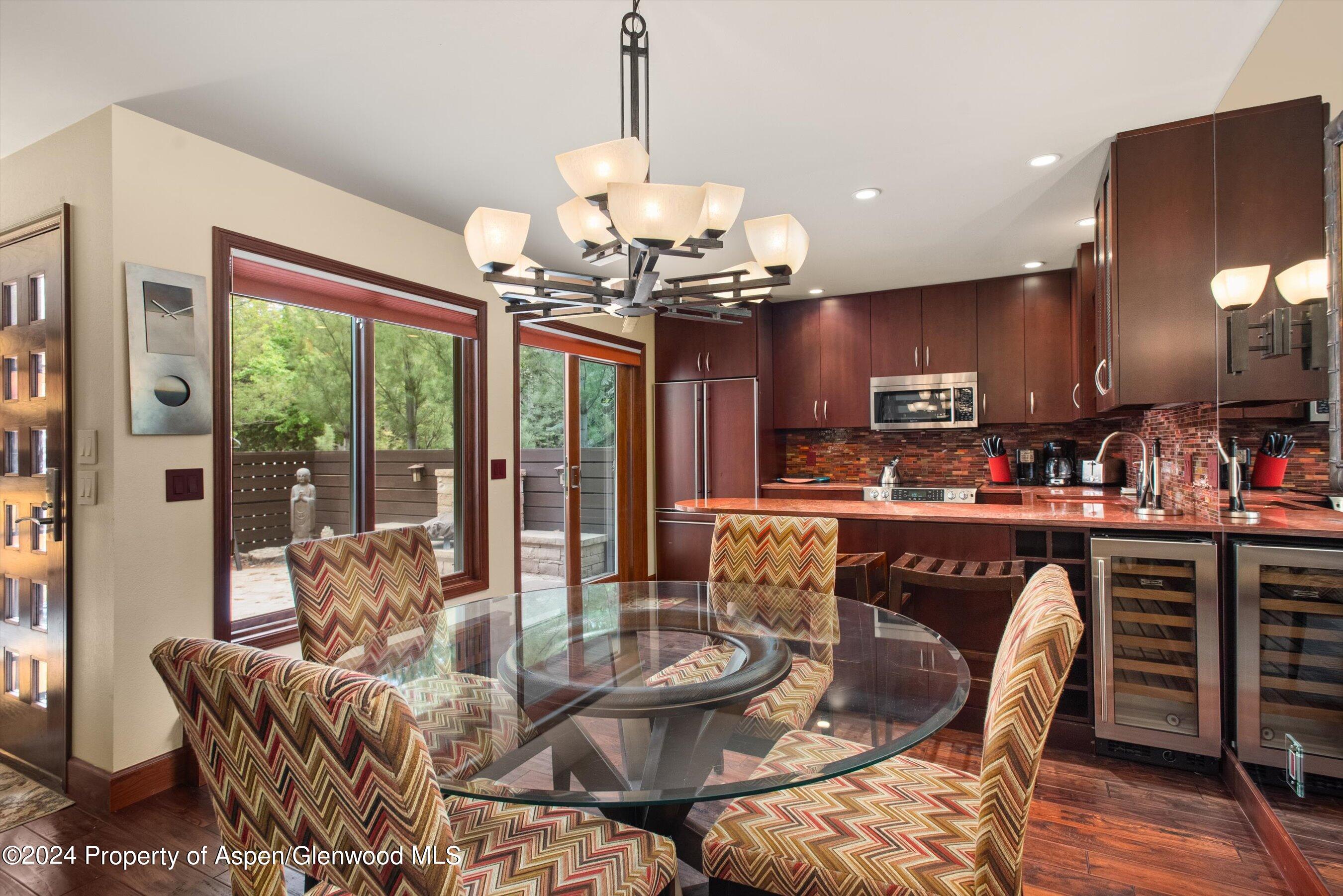 153 Wren Court Basalt, CO 81621 - Photo 8 of 21 a dining room with furniture a chandelier and window