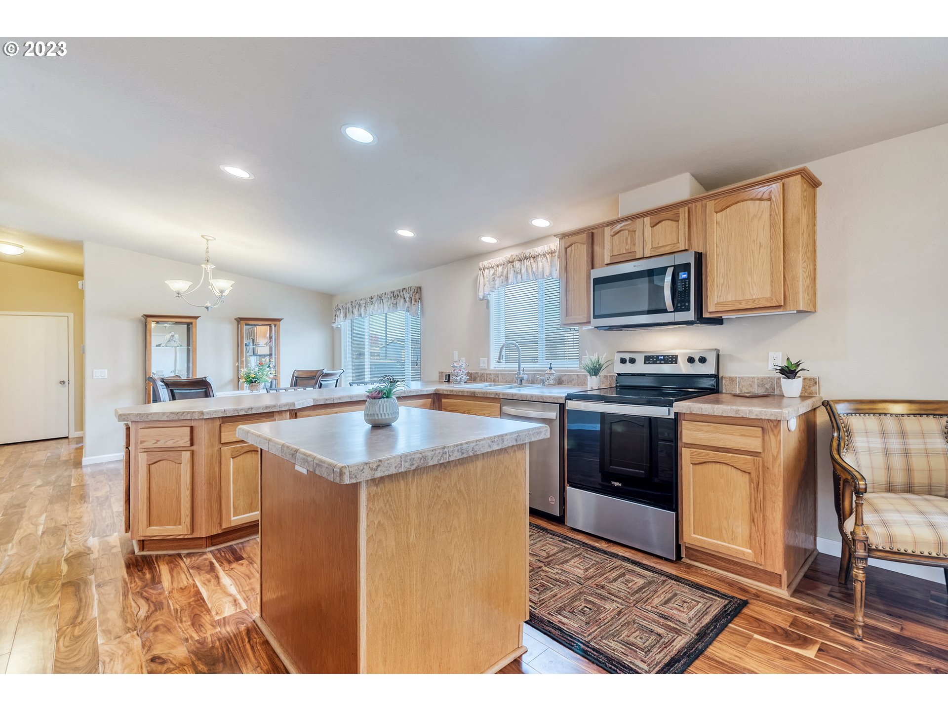 2601 Maia Loop Springfield, OR 97477 - Photo 12 of 29 a kitchen with kitchen island granite countertop a stove top oven a sink a counter top space and cabinets