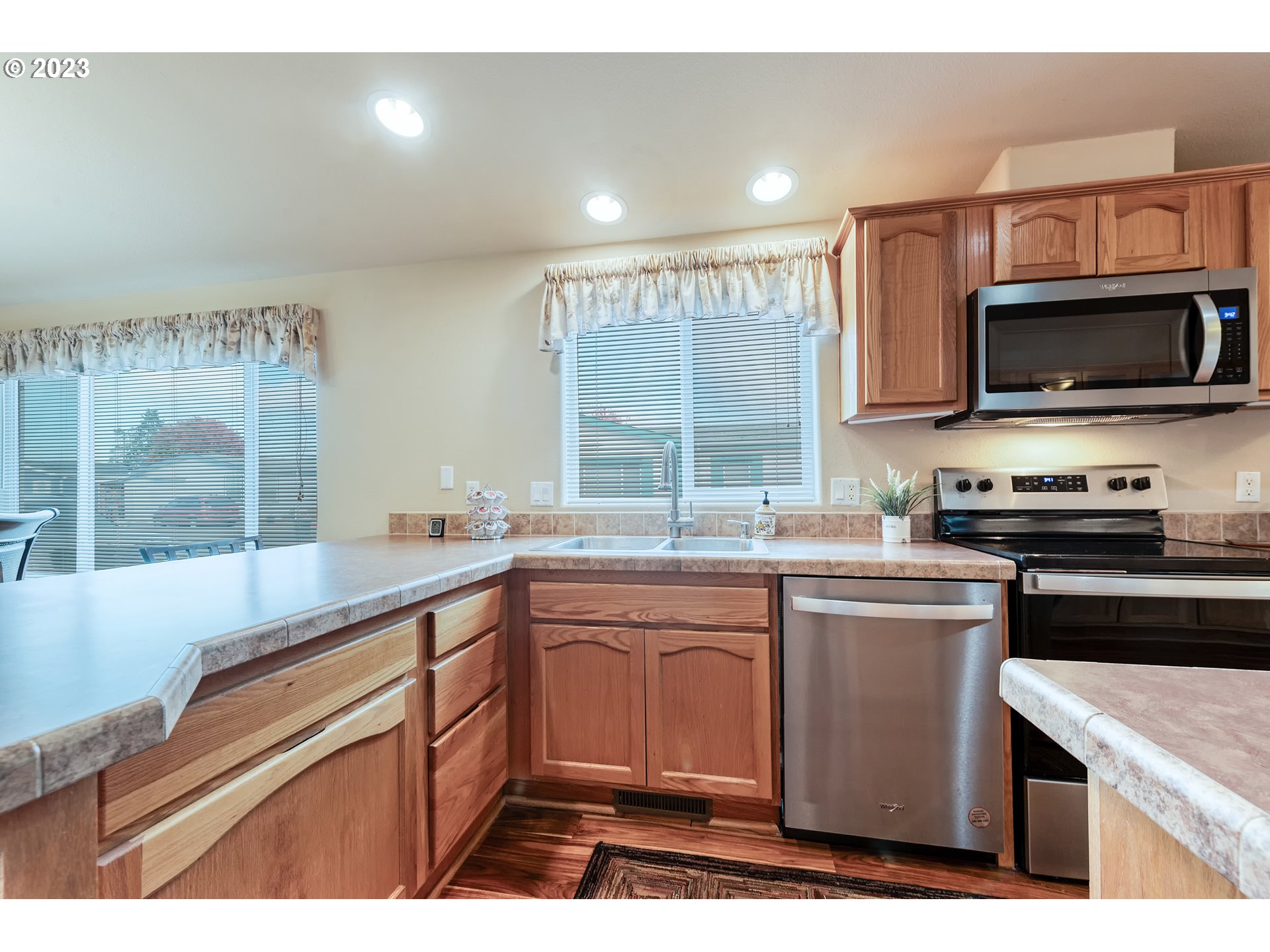 2601 Maia Loop Springfield, OR 97477 - Photo 10 of 29 a kitchen with stainless steel appliances granite countertop a sink and stove top oven
