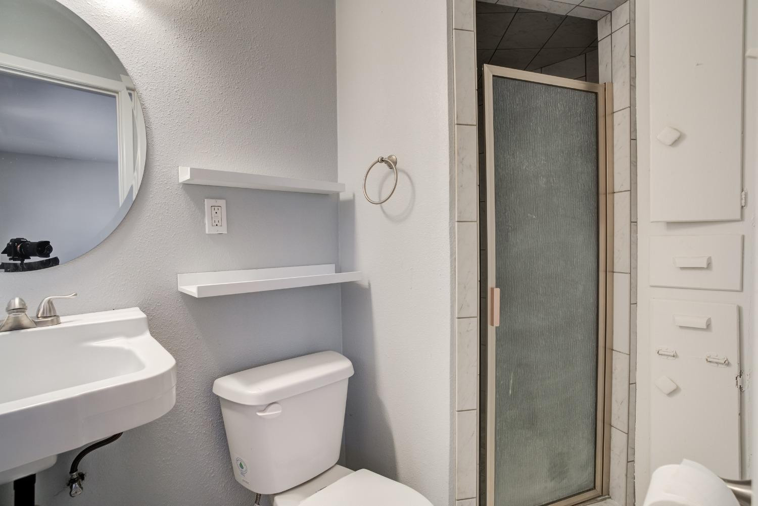 3011 44th Street Lubbock, TX 79413 - Photo 17 of 19 a bathroom with a toilet a sink and mirror