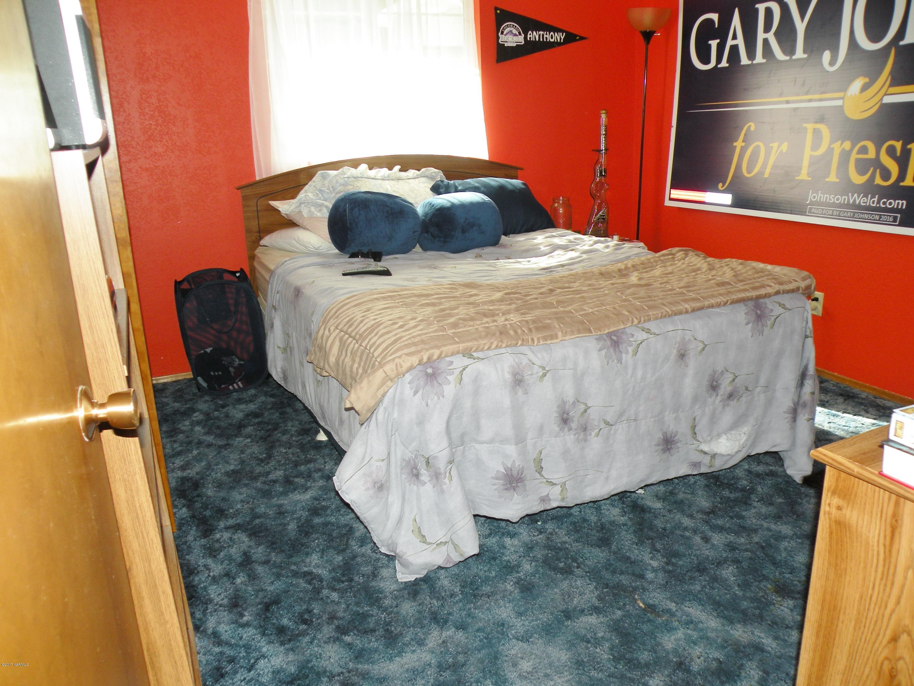 711 Meadowbrook Road Yakima, WA 98903 - Photo 14 of 22 a bed sitting in a bedroom next to a cabinet