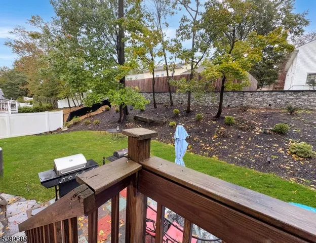 a view of a chairs and table in the backyard