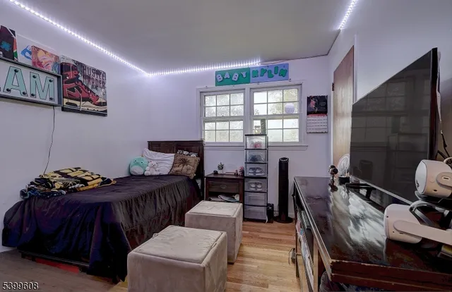 a bedroom with furniture and wooden floor