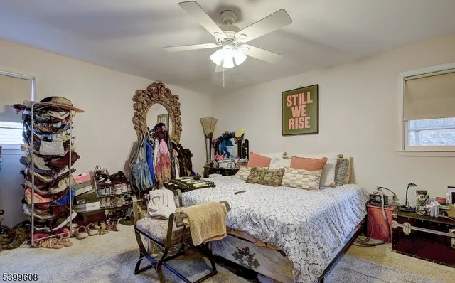 a bedroom with bed and a chandelier