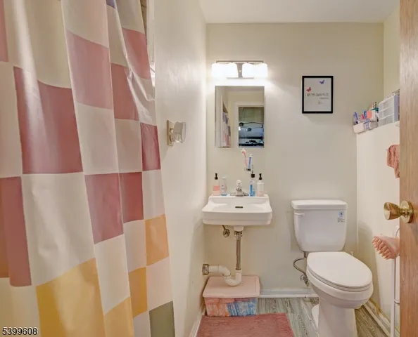 a bathroom with a sink toilet and mirror