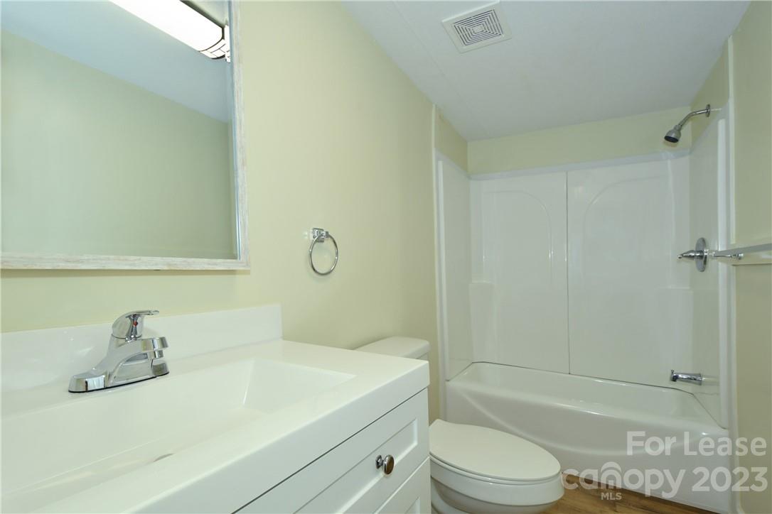 115 Buckhead Road, Unit 111 Harmony, NC 28634 - Photo 15 of 19 a bathroom with a sink a toilet and shower