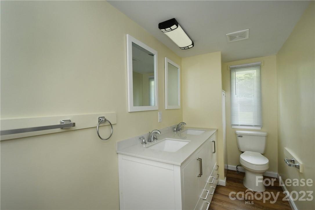 115 Buckhead Road, Unit 111 Harmony, NC 28634 - Photo 16 of 19 a bathroom with a sink mirror vanity and toilet