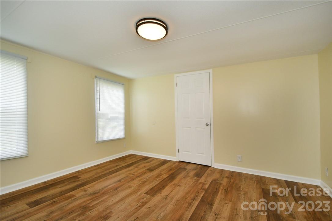 115 Buckhead Road, Unit 111 Harmony, NC 28634 - Photo 8 of 19 a view of an empty room with wooden floor and a window