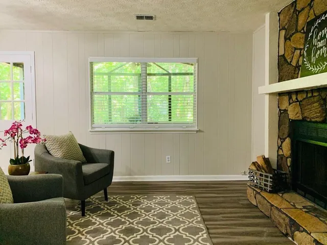a living room with furniture and a potted plant