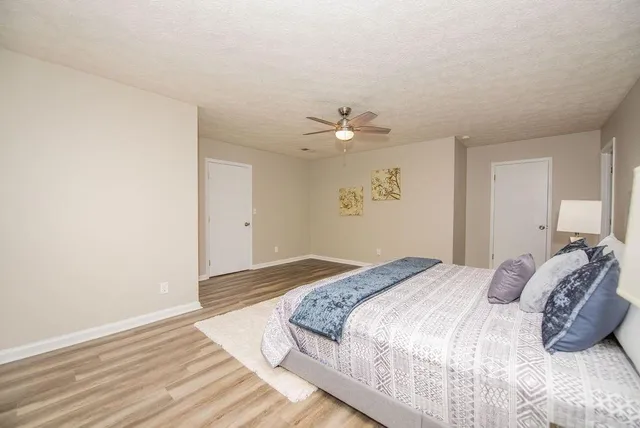 a bedroom with a bed and a chandelier