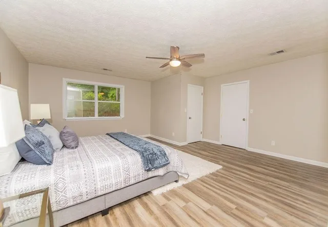 a bedroom with a large bed and a window