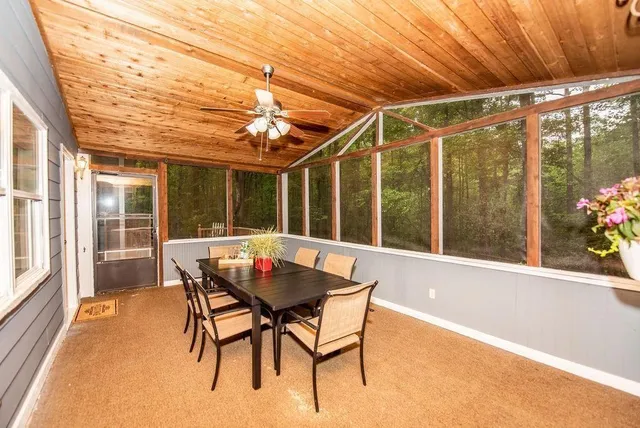 a view of a patio with a table and chairs and floor to ceiling window