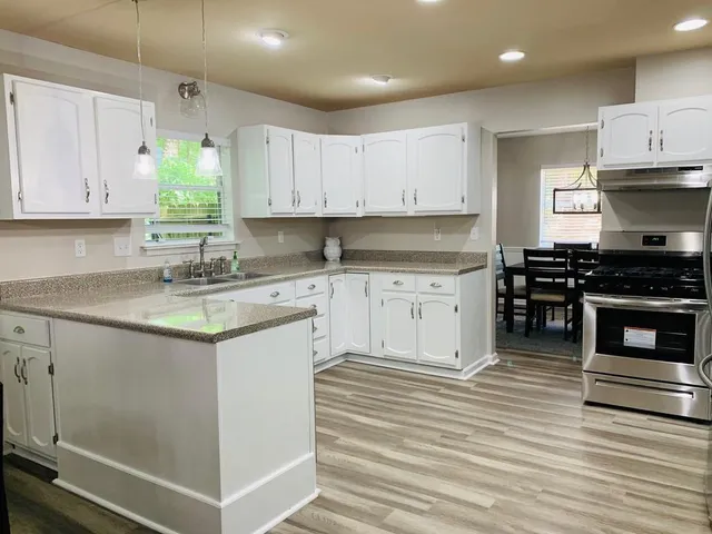 a kitchen with a sink stove and cabinets