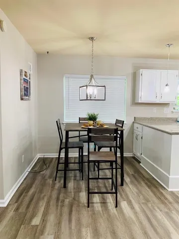 a dining room with a wooden table and chairs