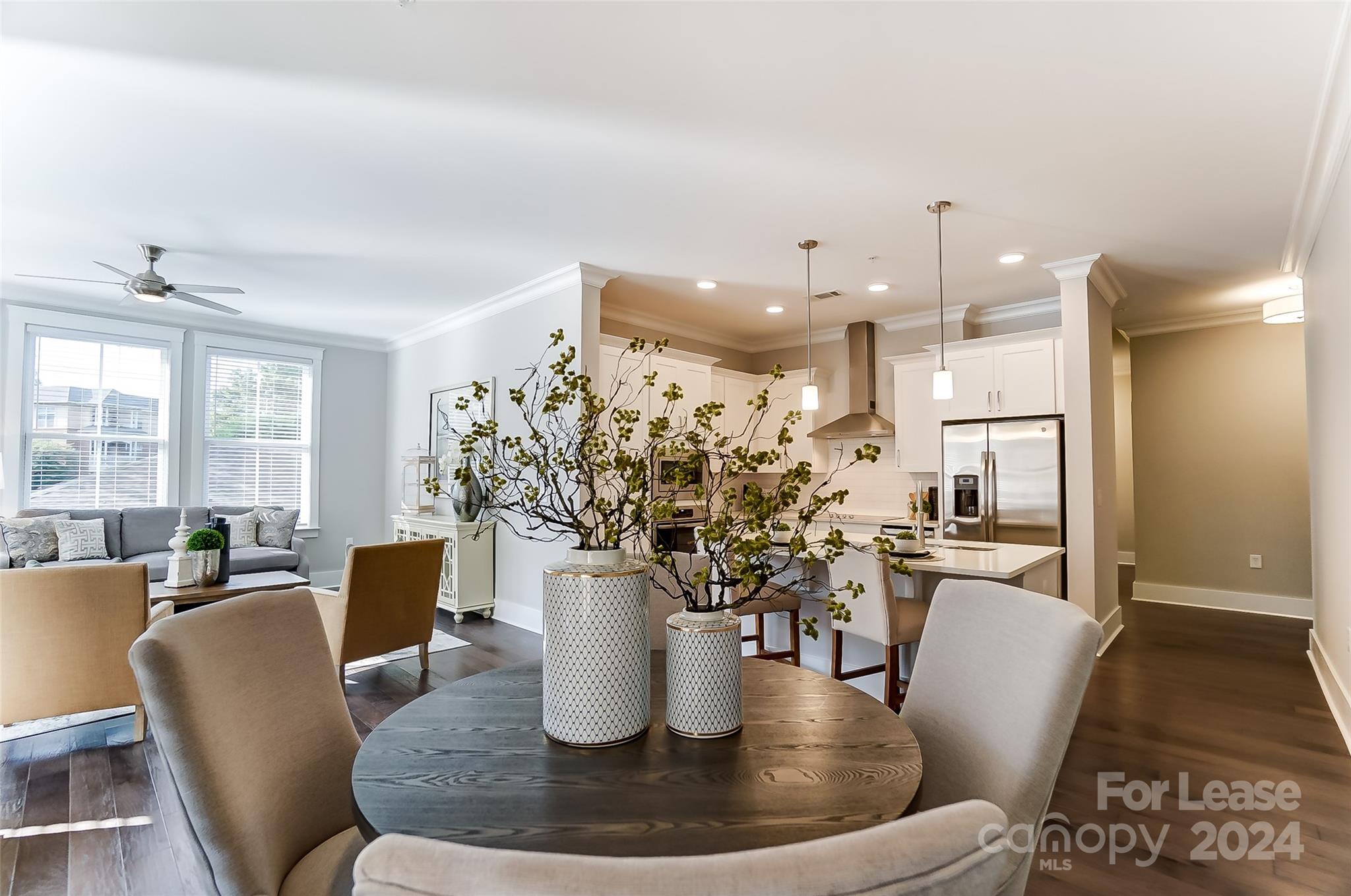 830 Providence Road, Unit 401 Charlotte, NC 28207 - Photo 11 of 24 a dining room with furniture a wooden floor and a chandelier