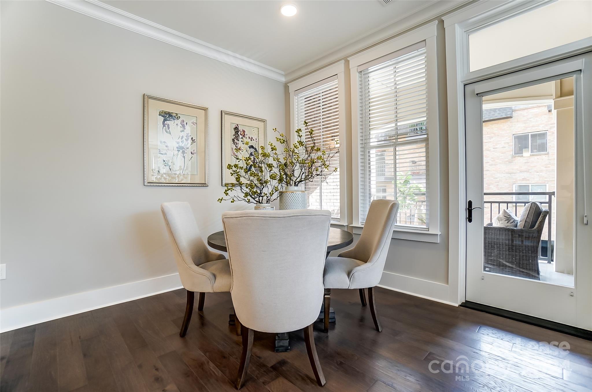 830 Providence Road, Unit 401 Charlotte, NC 28207 - Photo 12 of 24 a view of a dining room with furniture window and wooden floor