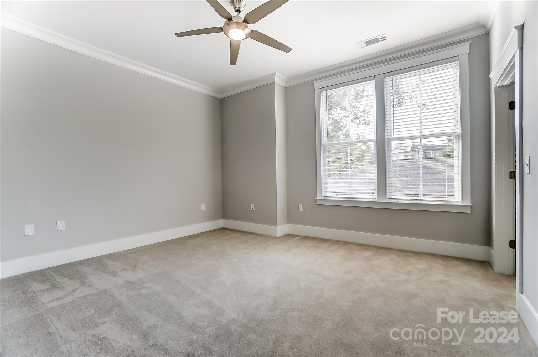 830 Providence Road, Unit 401 Charlotte, NC 28207 - Photo 13 of 24 a view of an empty room with a window