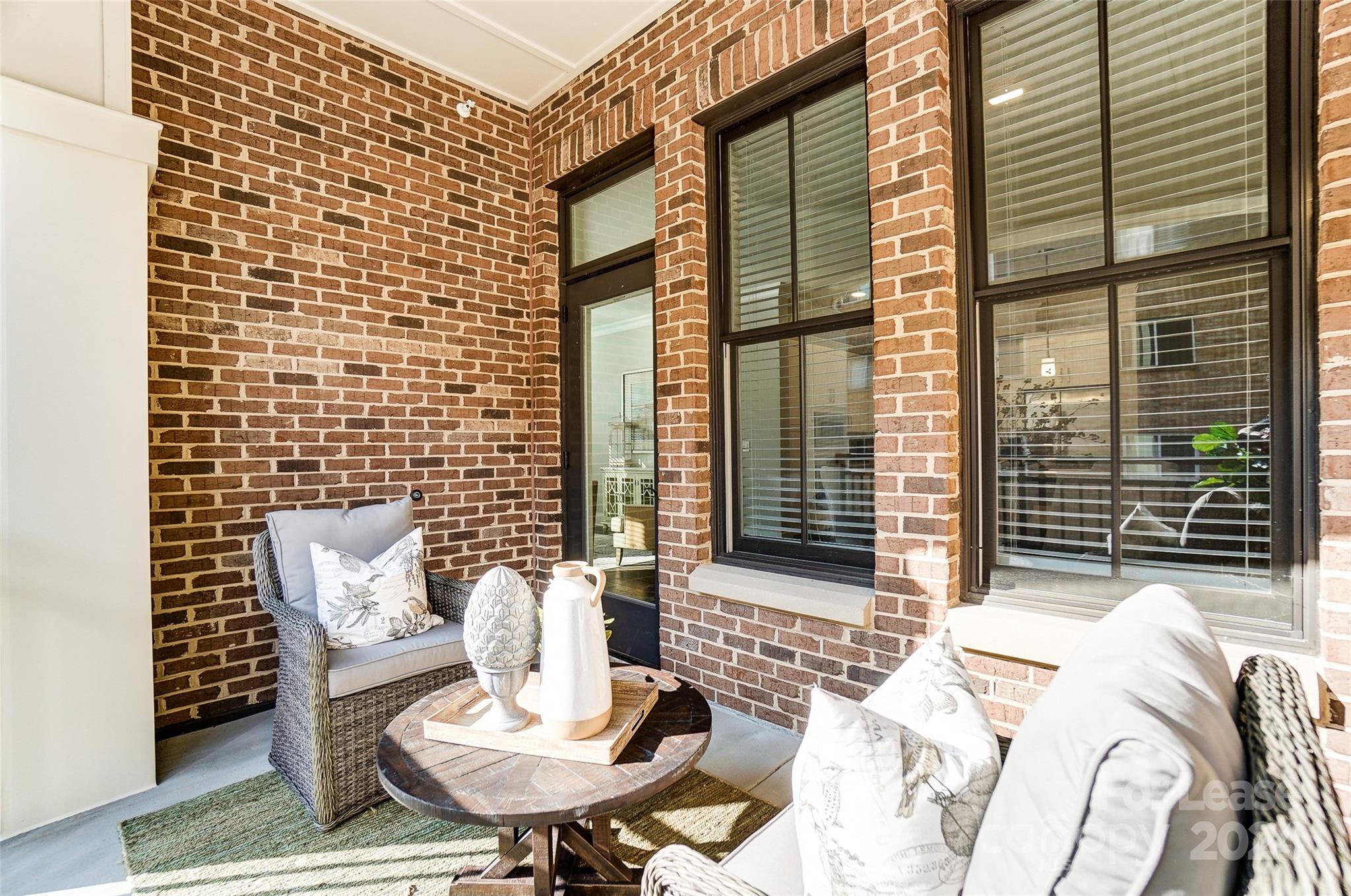 830 Providence Road, Unit 401 Charlotte, NC 28207 - Photo 18 of 24 a balcony view with a couch and wooden floor