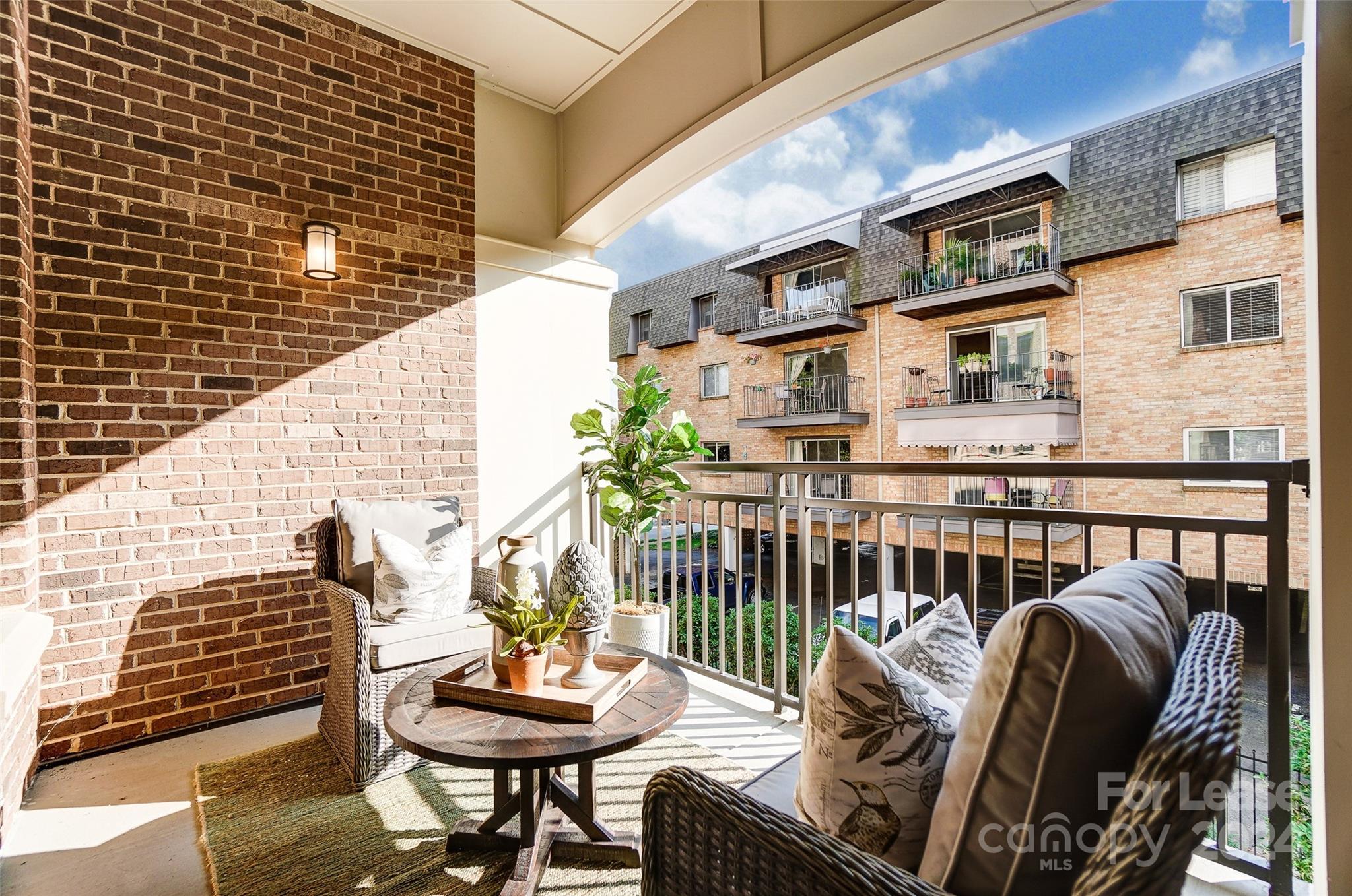 830 Providence Road, Unit 401 Charlotte, NC 28207 - Photo 19 of 24 a balcony with table and chairs