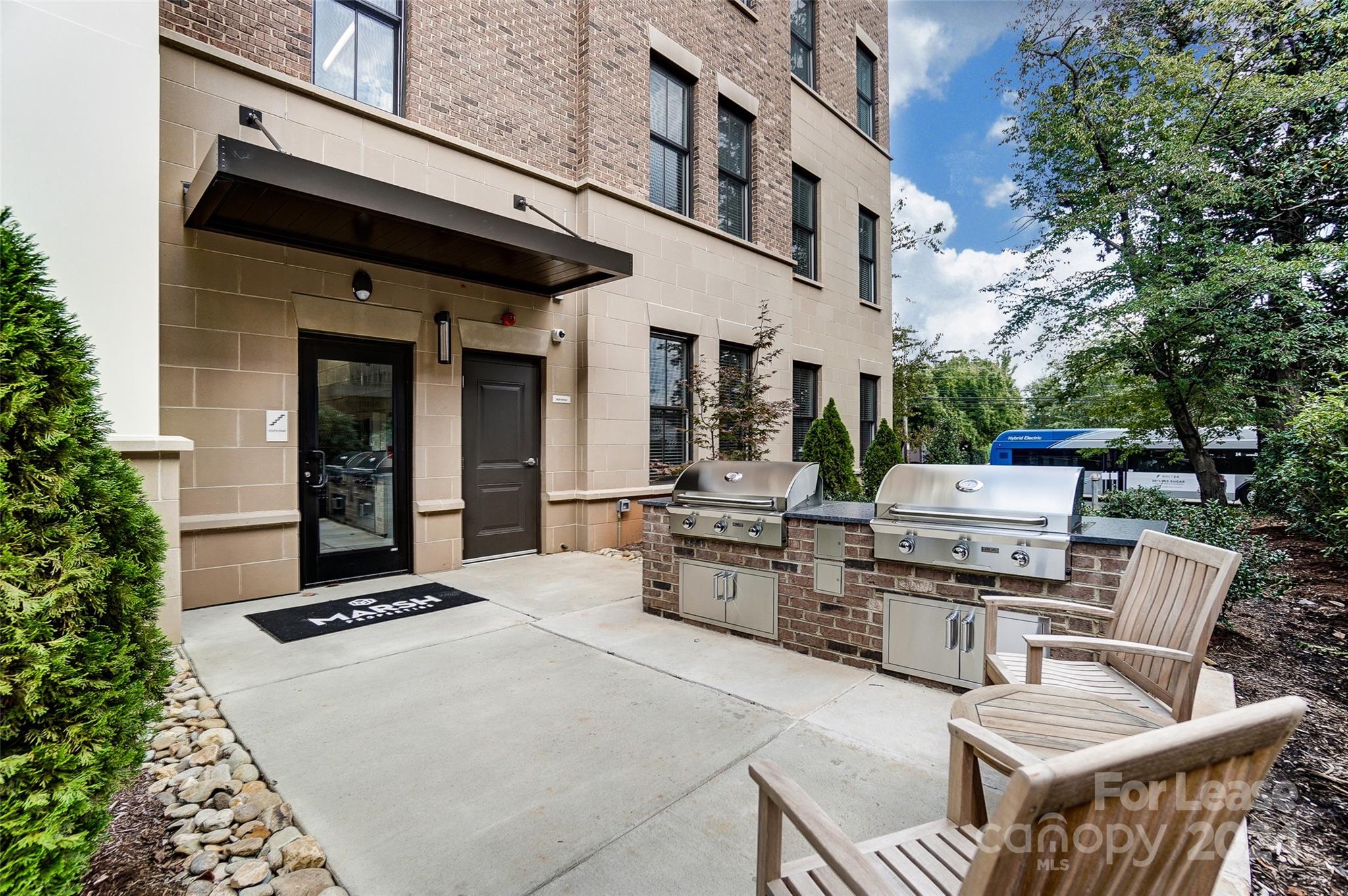 830 Providence Road, Unit 401 Charlotte, NC 28207 - Photo 20 of 24 a view of a patio with a dining table and chairs with wooden floor