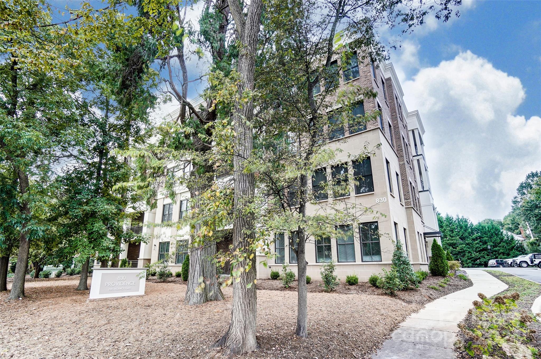 830 Providence Road, Unit 401 Charlotte, NC 28207 - Photo 2 of 24 a view of a building with a tree