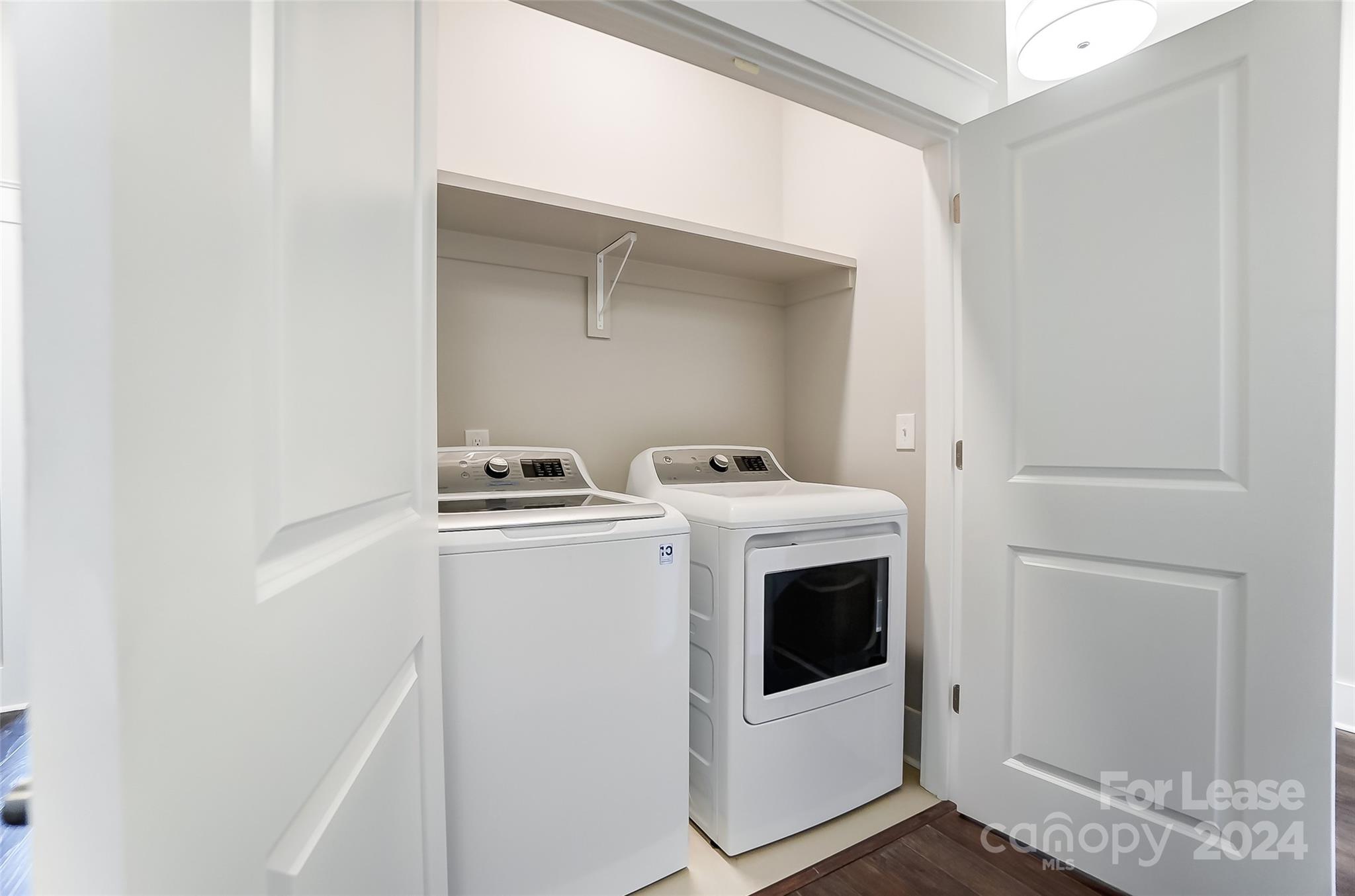 830 Providence Road, Unit 401 Charlotte, NC 28207 - Photo 22 of 24 a utility room with dryer and washer