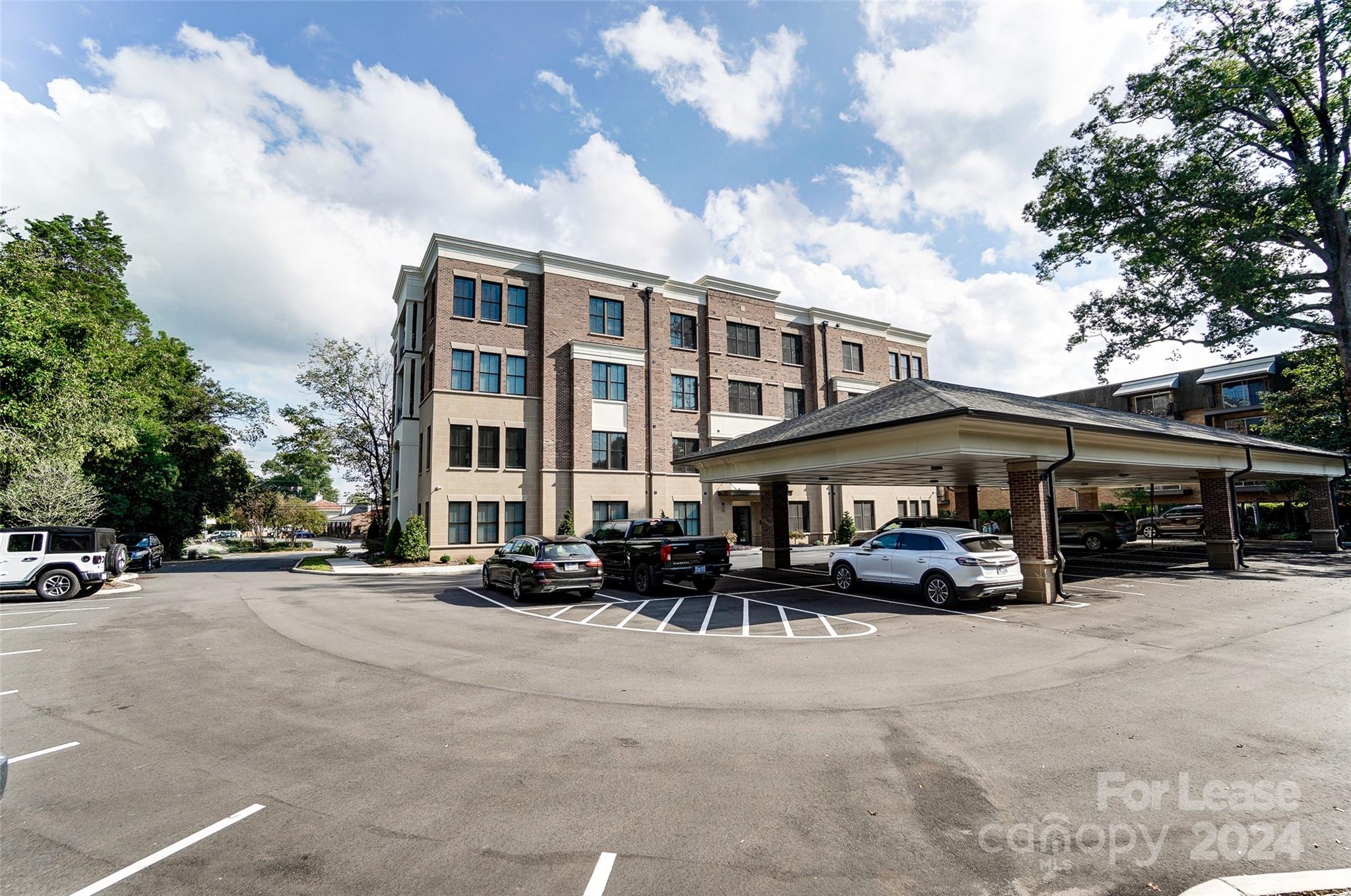 830 Providence Road, Unit 401 Charlotte, NC 28207 - Photo 23 of 24 a couple of cars parked in front of a building