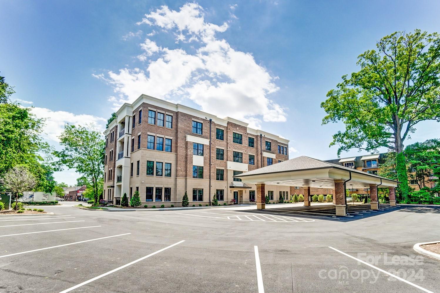 830 Providence Road, Unit 401 Charlotte, NC 28207 - Photo 24 of 24 a front view of a building with lot of cars and trees