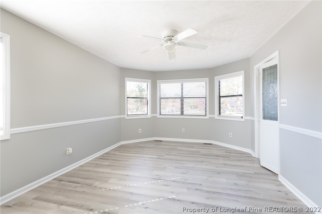 4629 Legion Road Hope Mills, NC 28348 - Photo 7 of 21 a view of an empty room with wooden floor and a window