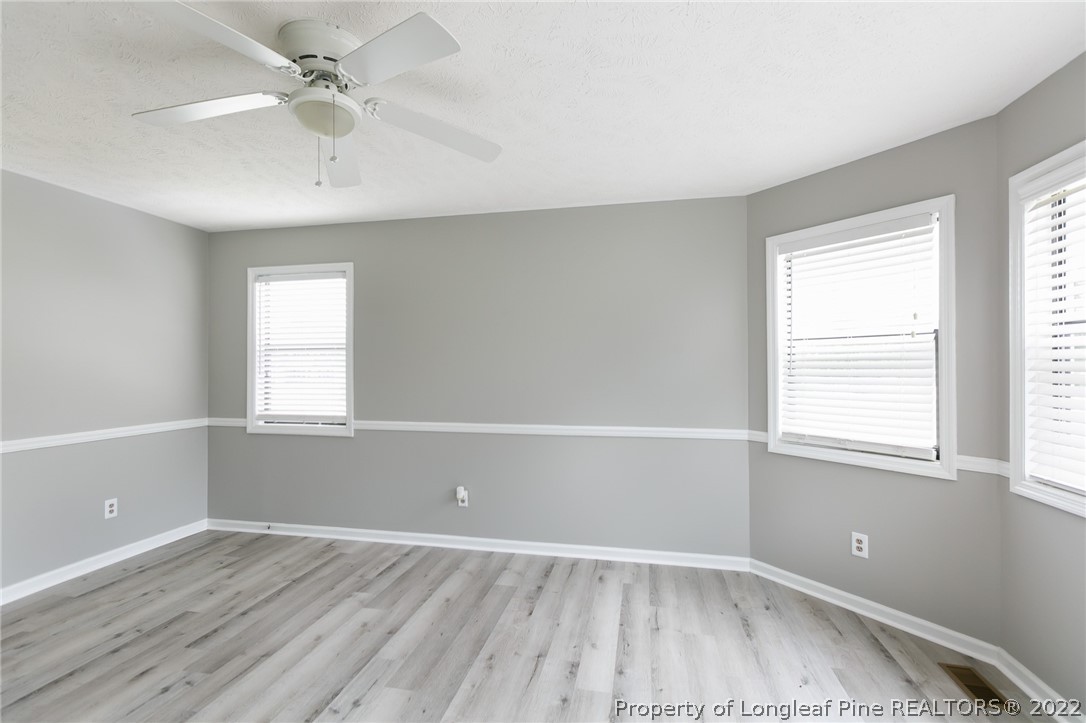 4629 Legion Road Hope Mills, NC 28348 - Photo 8 of 21 an empty room with wooden floor and windows