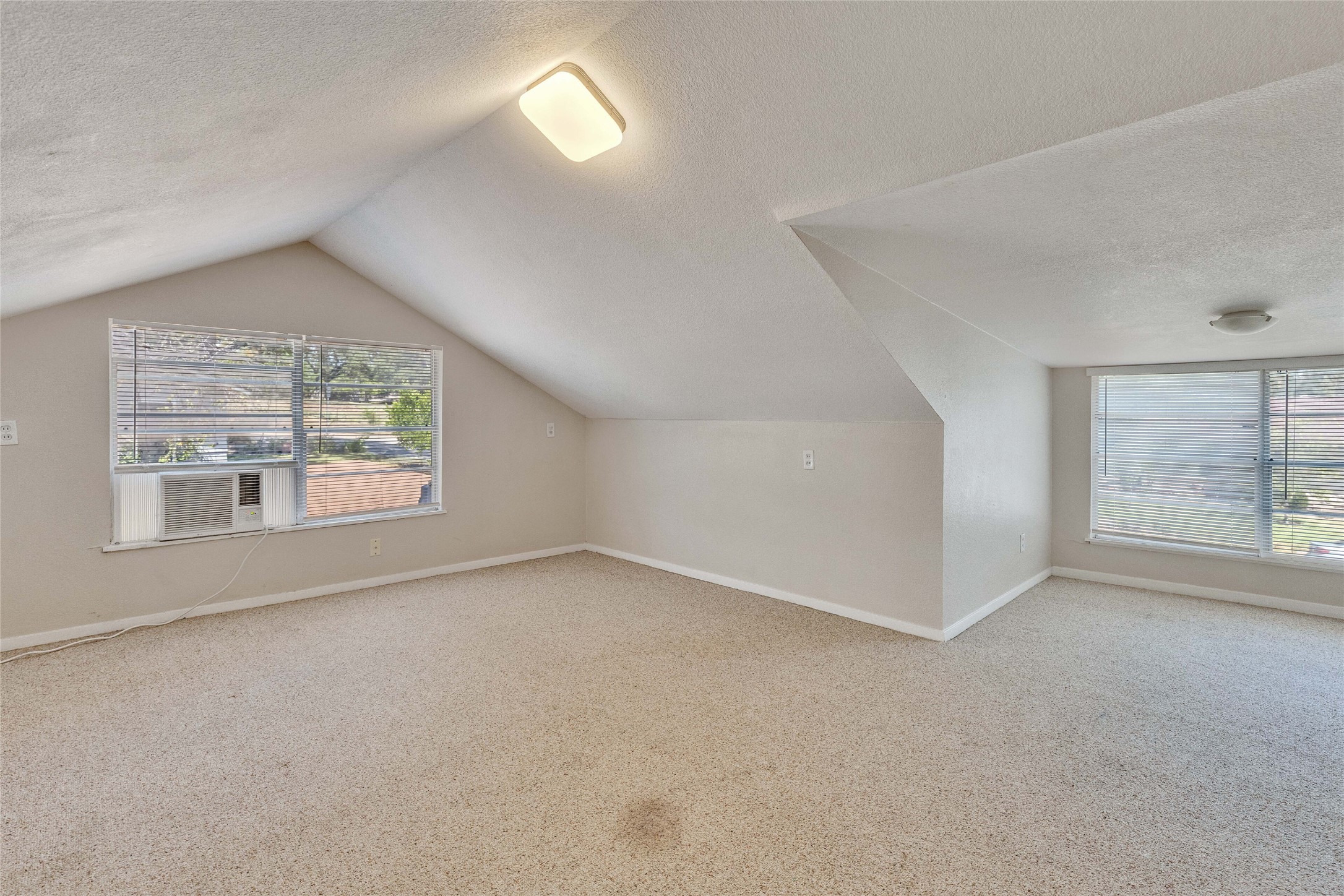 3810 Brookview Road Austin, TX 78722 - Photo 20 of 27 Angled ceilings and carpeted flooring define this versatile upstairs loft space.