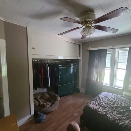 a bedroom with a bed and a window