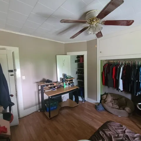 a bedroom with furniture and a gym equipment