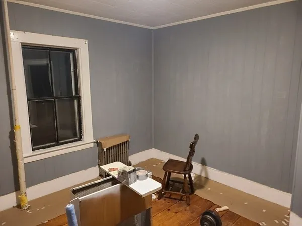 a view of a workspace with furniture and a window