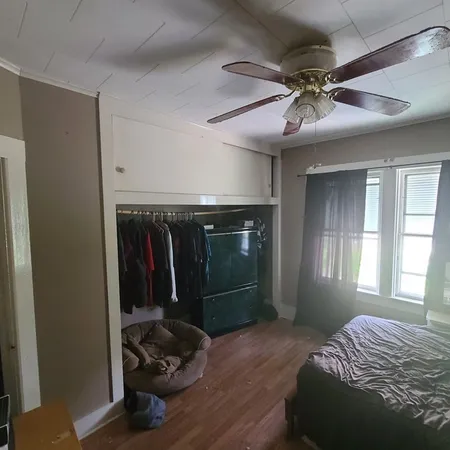 a bedroom with a bed and a window